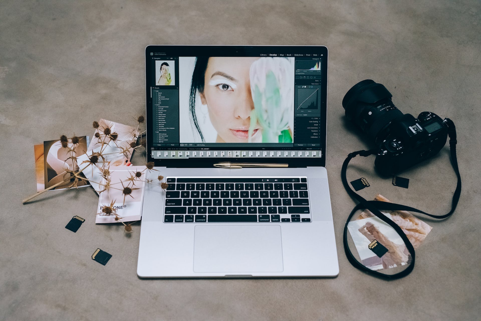 A Laptop and Dslr Camera on a Concrete Table by Leeloo The First